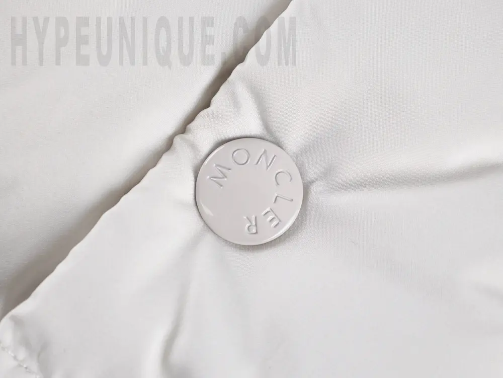 Branded button detail on the Mk Maya 70 Matte Coat.