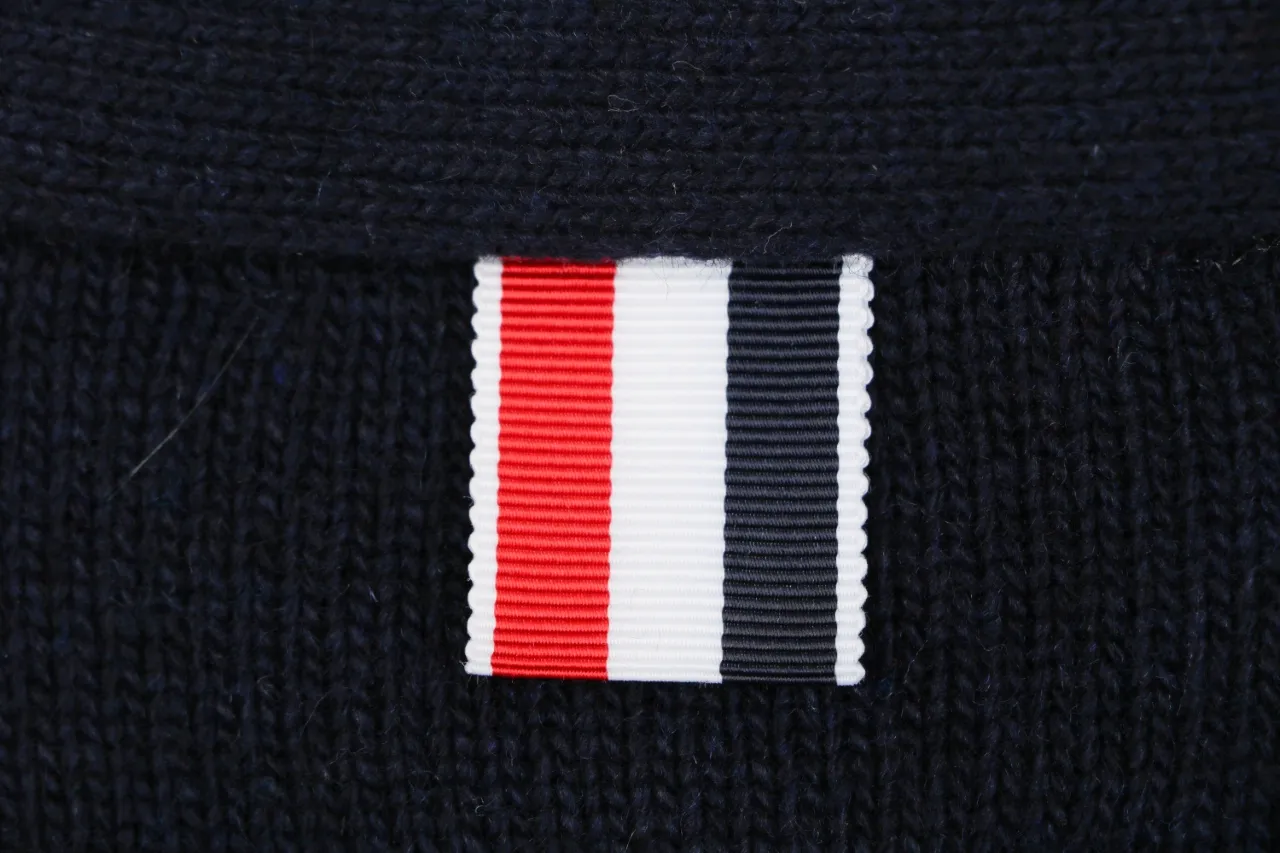 Tricolor grosgrain tab detail on navy knit cardigan