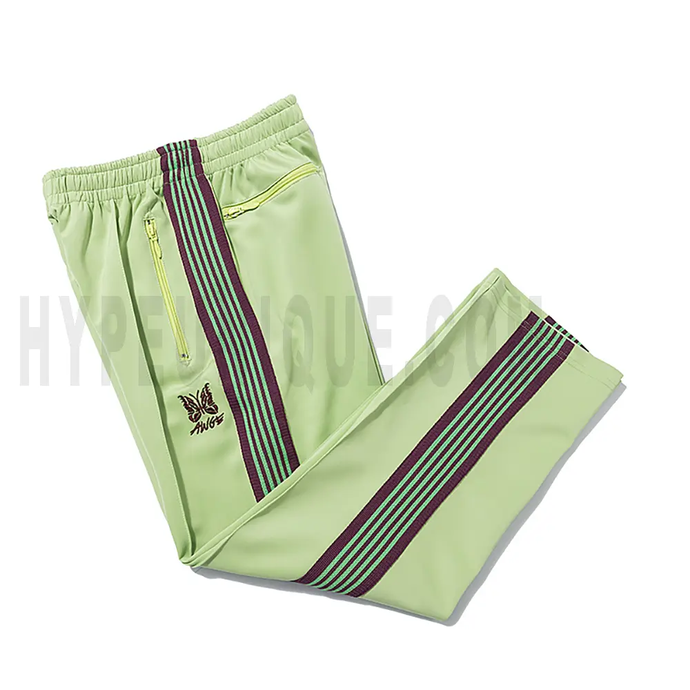 Side view of green track pants.