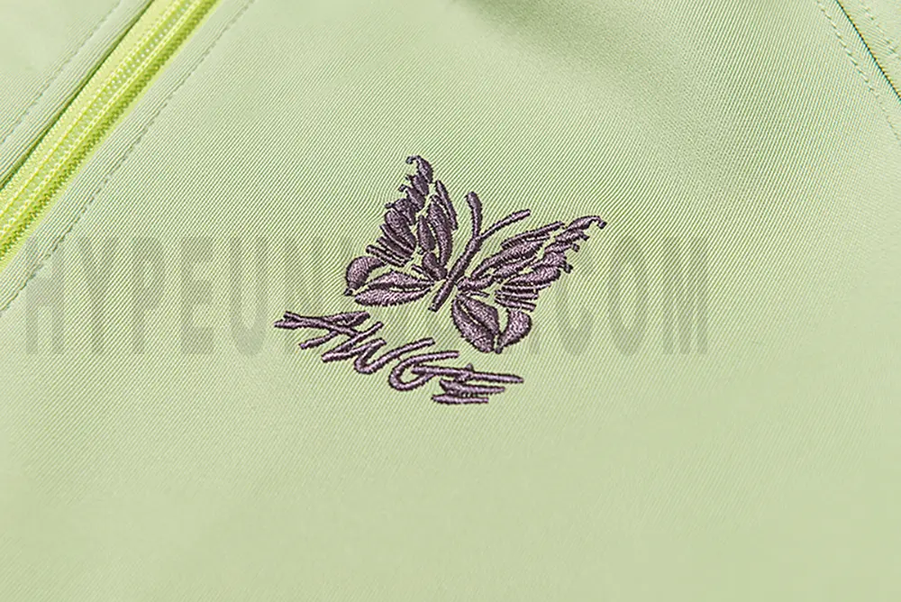 Close-up of butterfly embroidery detail on the chest of the jacket.