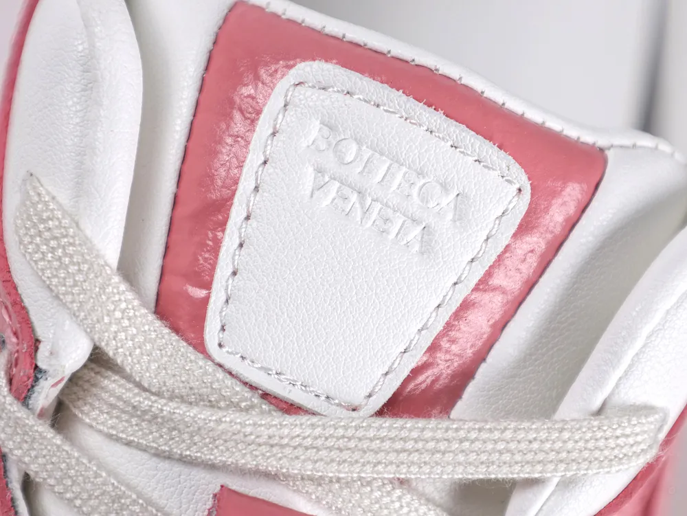 Close-up of the sneaker tongue featuring an embossed Bottega Veneta logo on a white leather patch.