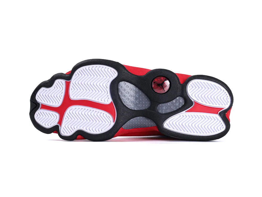 Red and white rubber shoe sole with textured grip and black accents.