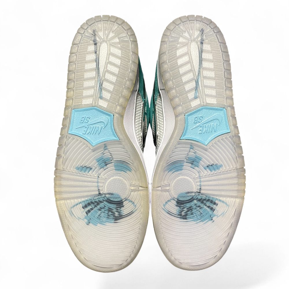 Turquoise suede and white mesh sneakers angled side-by-side, featuring a black logo, white laces, and grey soles.