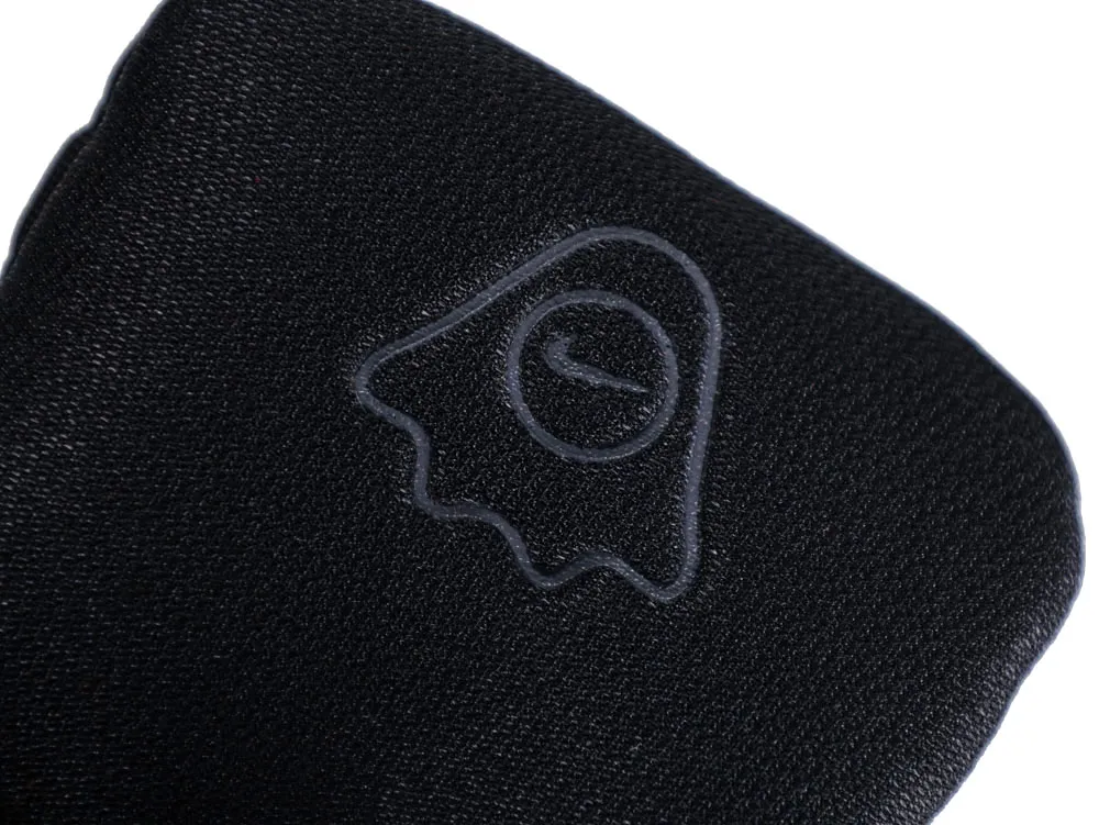 Black fabric product featuring a ghostly silhouette design embossed on the surface.