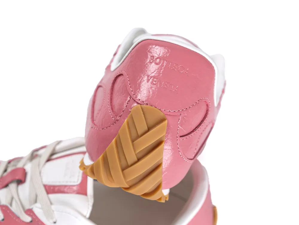 Heel view of pink sneakers showing the Bottega Veneta logo and gum rubber wrap-up sole.