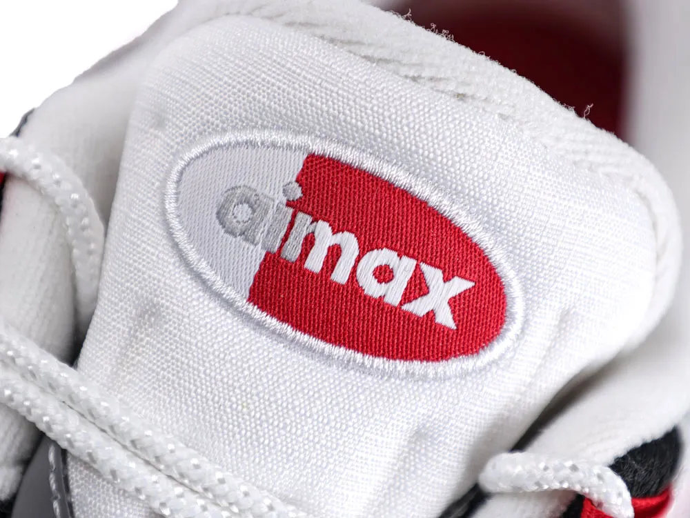 White fabric sneaker tongue with red logo design.