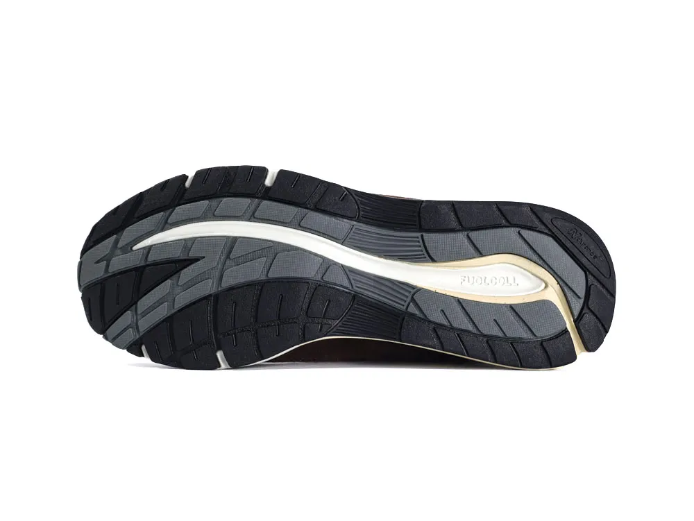 Black and gray rubber shoe sole with textured grip pattern.