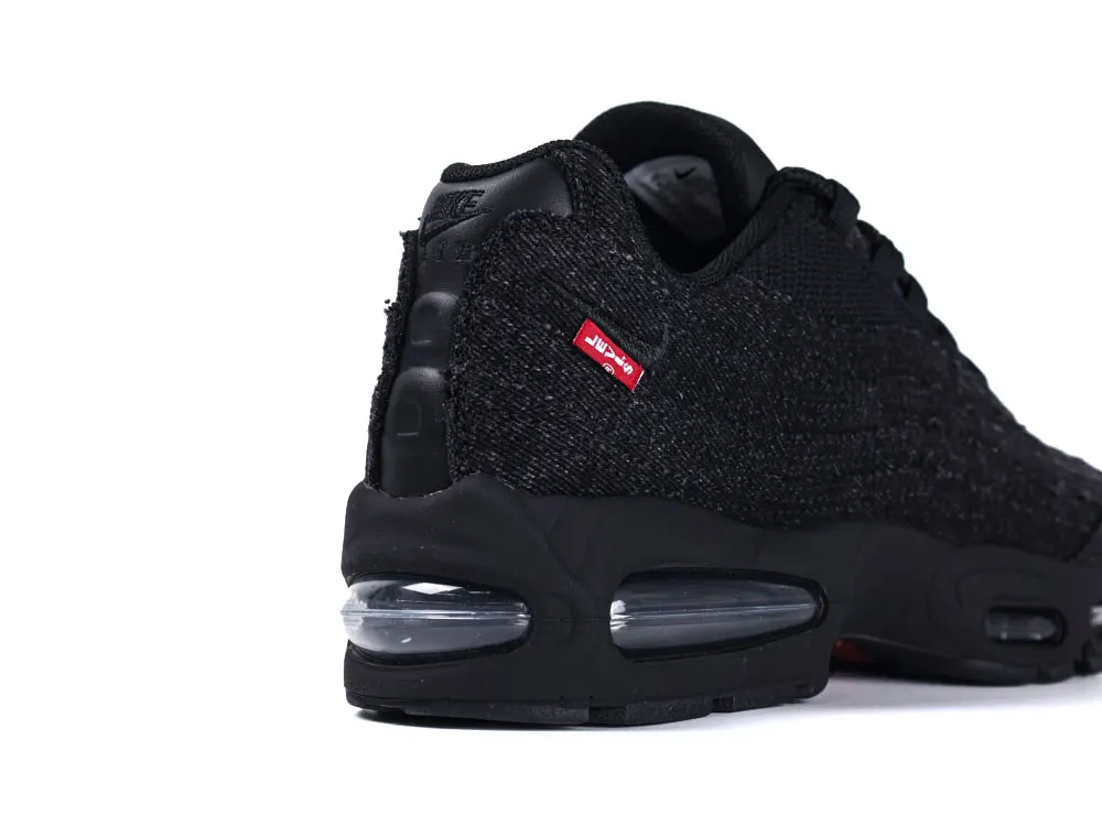 Black sneaker with knit fabric and visible air cushioning in the heel.