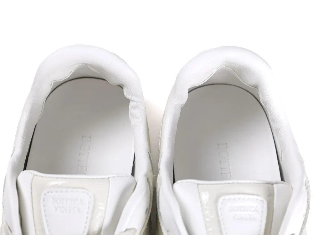 Top-down view showing the padded white leather ankle collar and dual tongue patches.