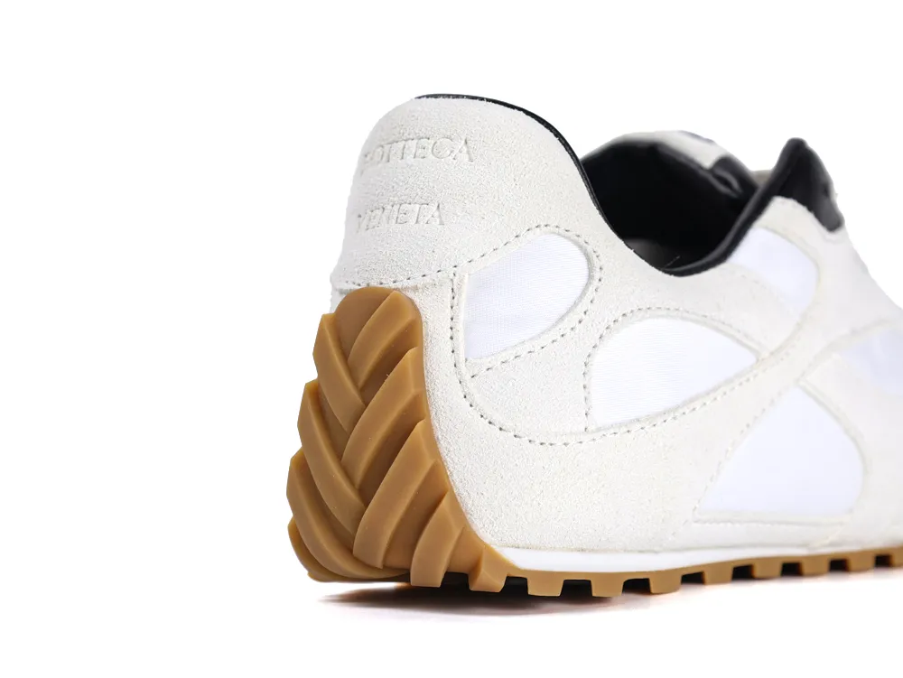 White and beige shoe with suede and fabric materials, featuring a textured rubber sole.