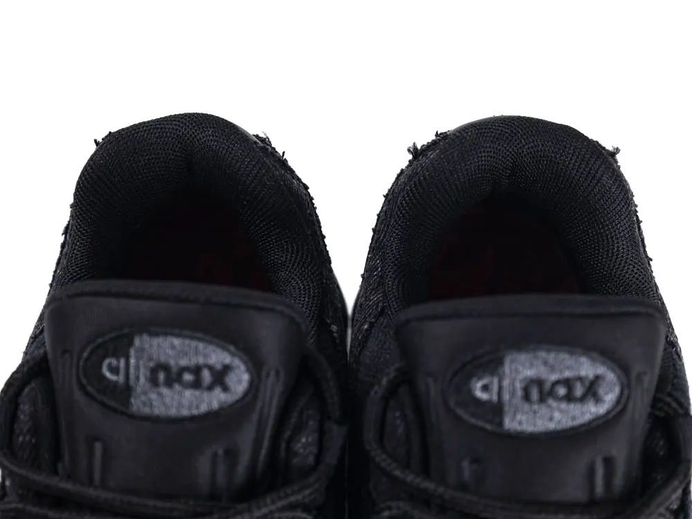 Black fabric sneakers with padded collars and branded leather tongue tags.