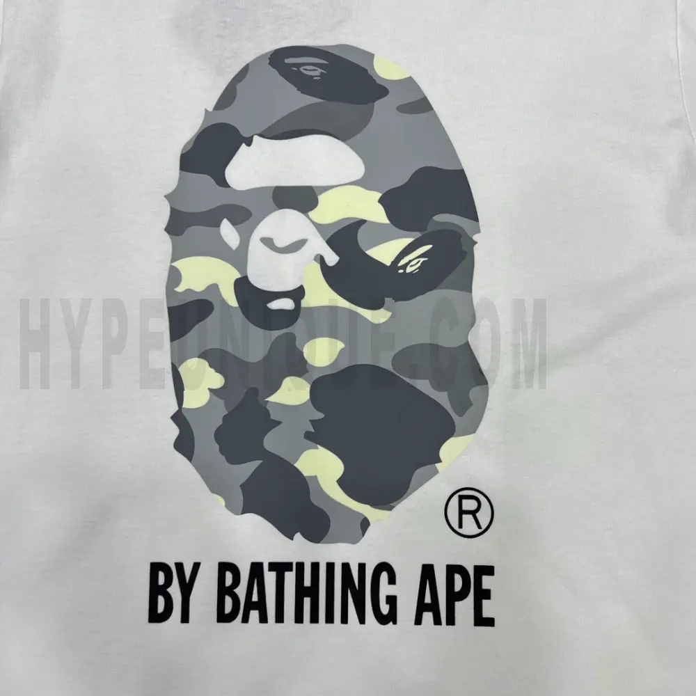 Detailed shot capturing the graphic print on the white tee's front panel.