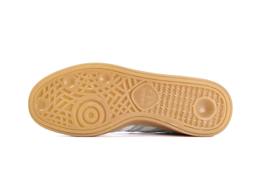 Tan rubber sole with textured grip pattern, featuring Adidas logo in the center.