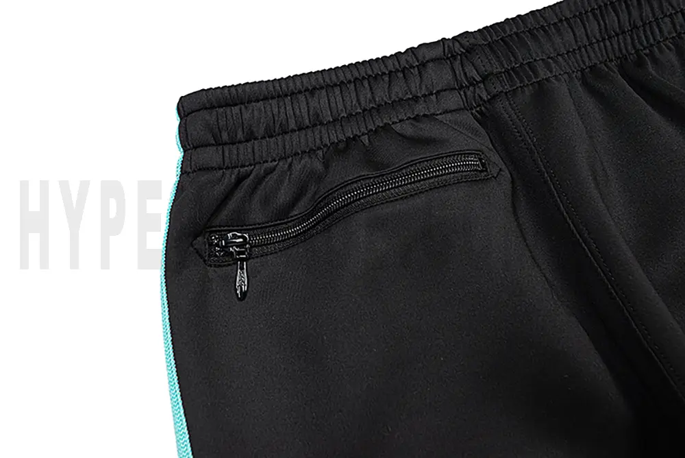 Detail of the back zip pocket on the track pants.