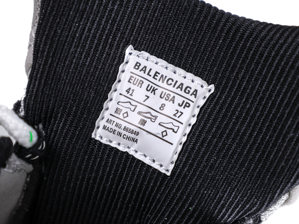 Black fabric shoe interior with white label displaying size and manufacturing details.