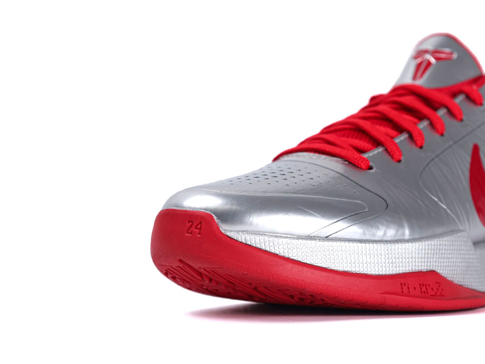 Silver and red sneaker with synthetic upper and rubber sole, featuring red laces.
