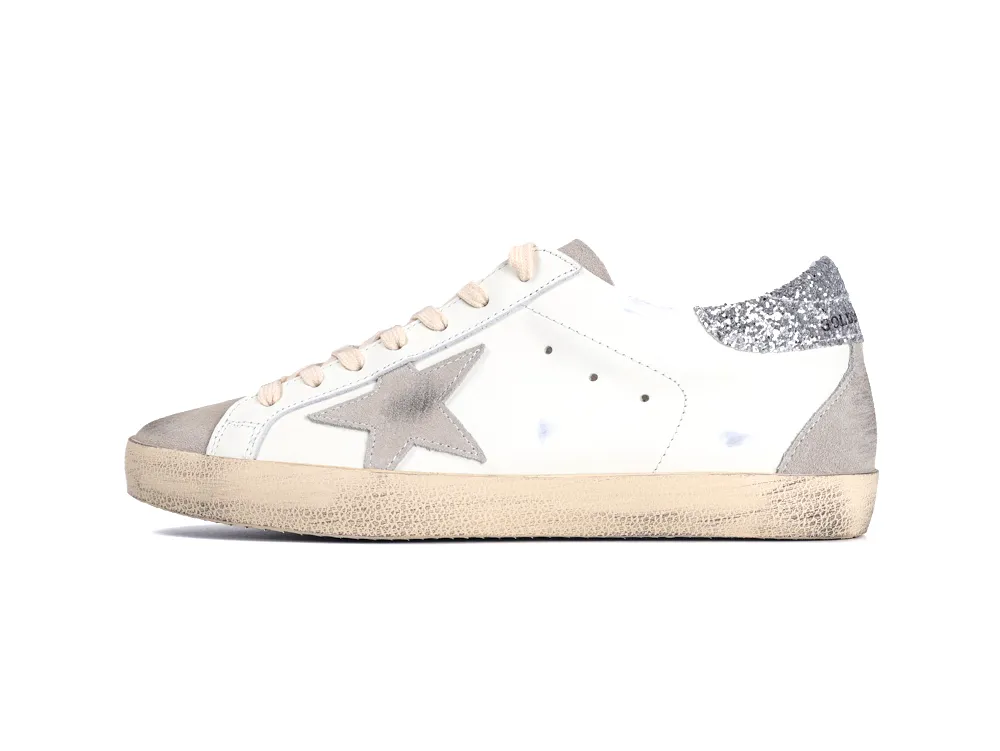 Side view of white Golden Goose Super Star sneaker with grey star and glitter heel