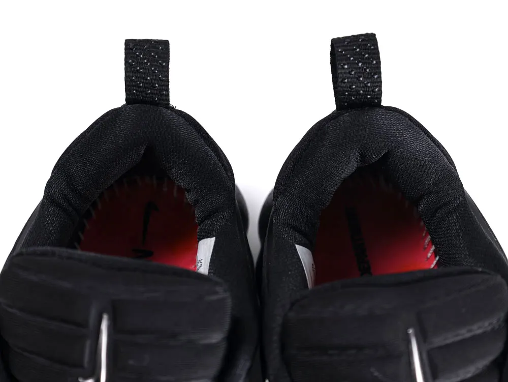 Black fabric shoe interiors with red insoles and textured pull tabs.