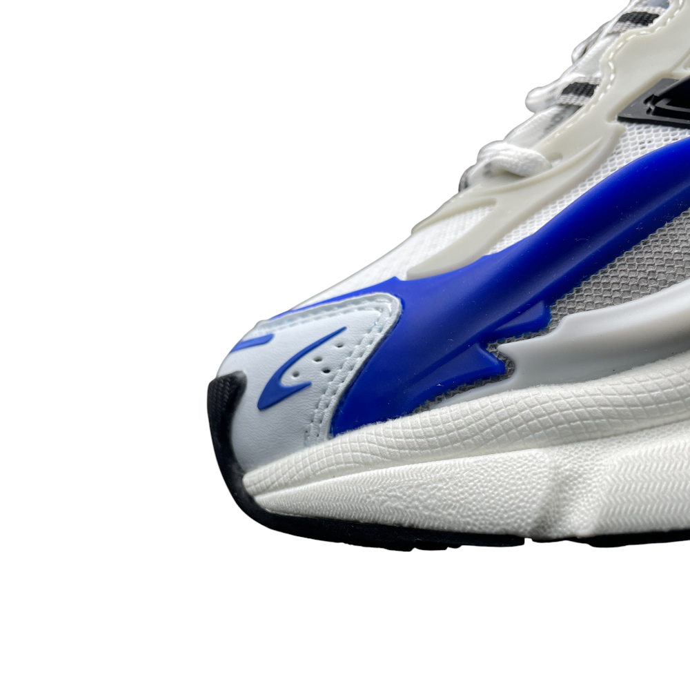 Close-up of a sneaker, showcasing white mesh and textured synthetic materials, with bold blue accents and subtle black details.