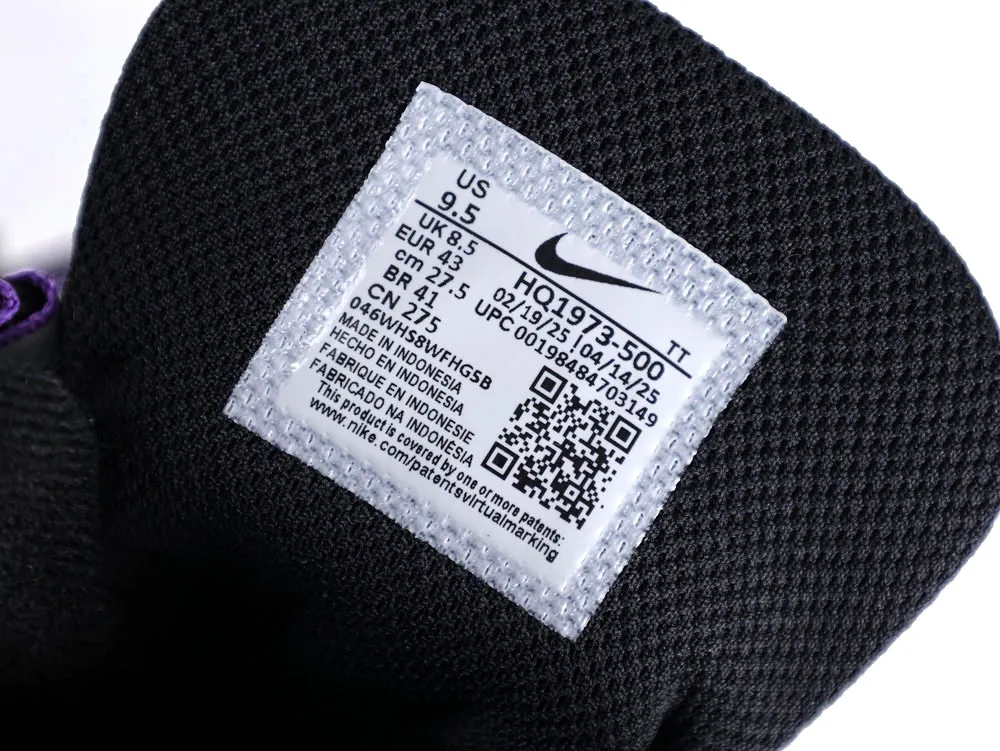 Black fabric sneaker tongue with white label, displaying size and manufacturing details.