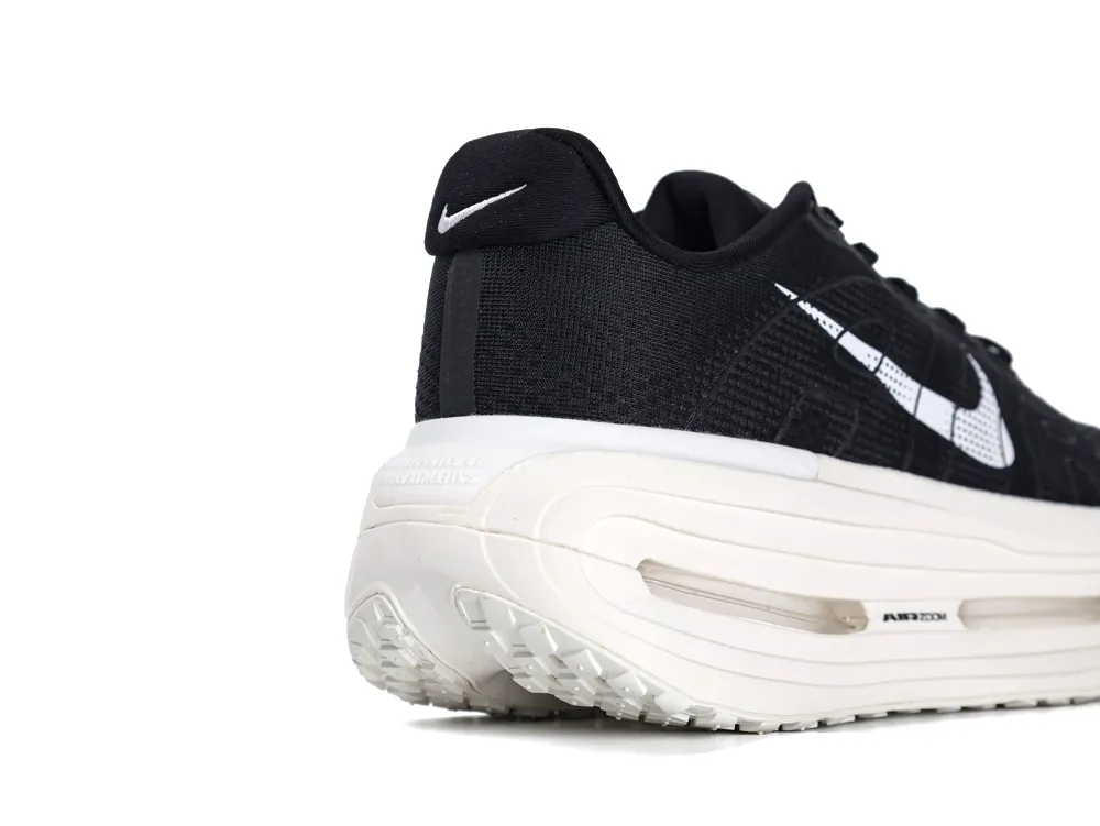 Black fabric sneaker with a white rubber sole and visible air cushioning.