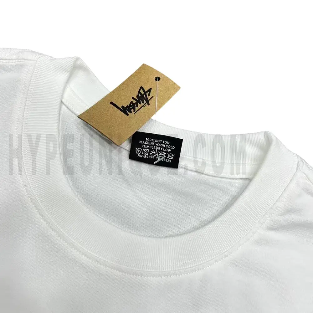 Neckline tag close-up, displaying garment care symbols and brand information with fashion-forward presentation.