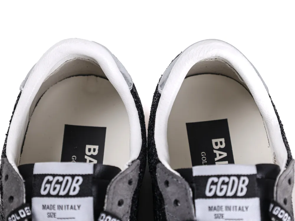 Close-up of the sneaker tongue with GGDB logo and white leather interior.