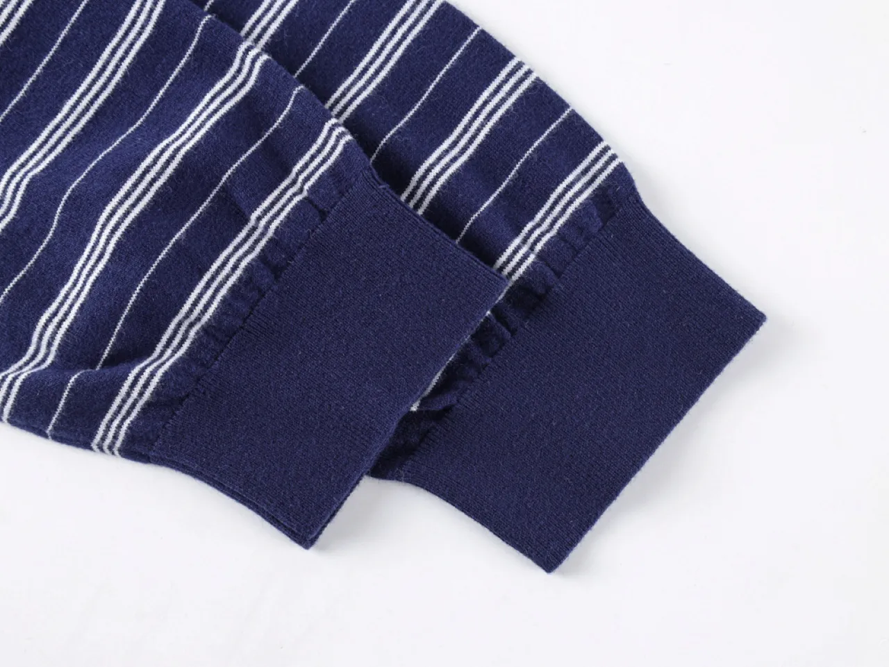 Navy blue striped fabric sleeve cuff, cotton material, with white lines.