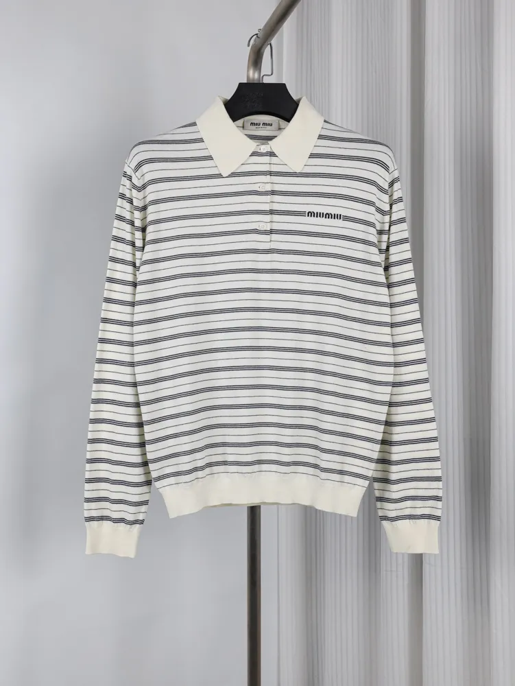 White and gray cotton sweater with stripes, button-up collar, and ribbed cuffs.