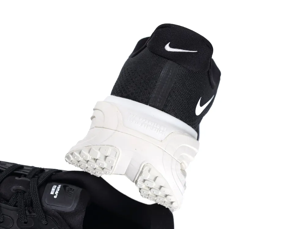 Black and white sneaker heel with rubber sole, showcasing textured grip.
