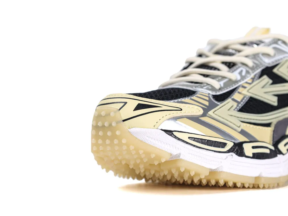 Close-up of a sneaker's beige synthetic upper with a textured rubber sole.