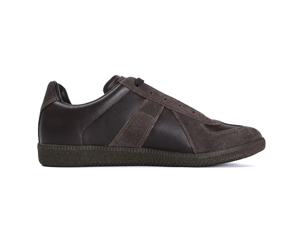 Dark brown suede and leather sneaker with textured rubber sole, side view.