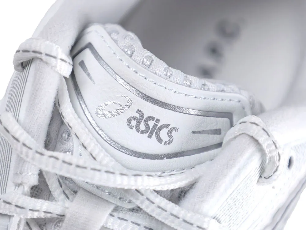 Close-up of a white leather shoe tongue with metallic silver detailing and laces.