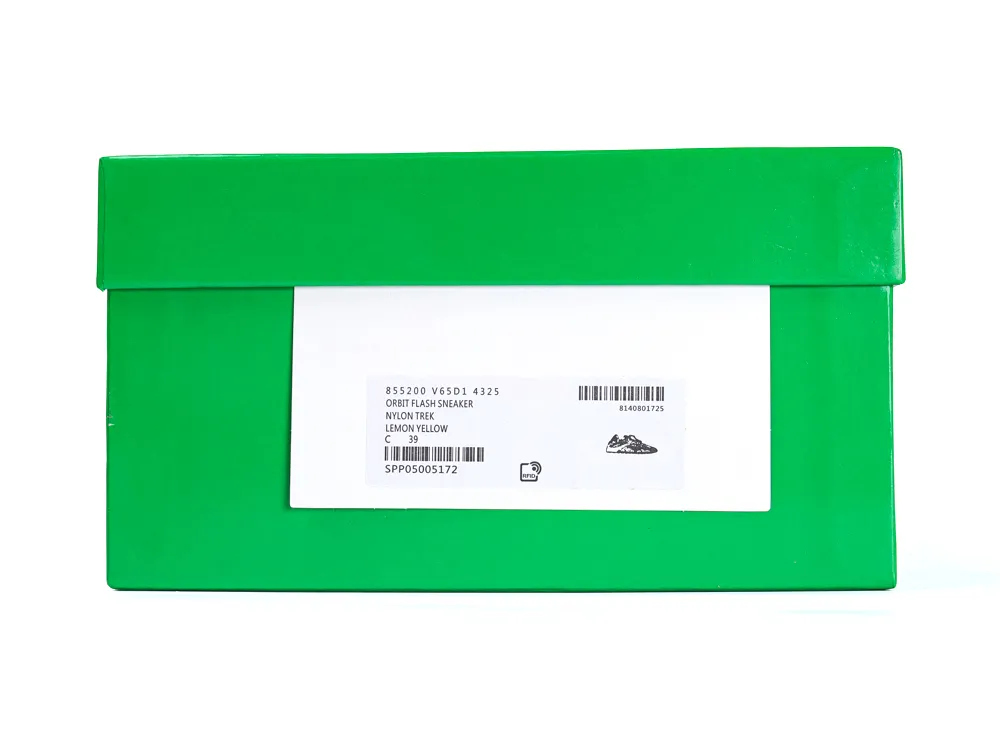 Green cardboard shoe box with white label containing printed text and barcode.