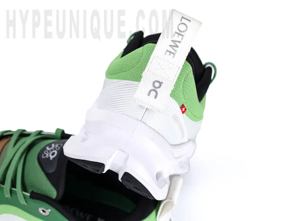 Rear heel view of the Lo x ON Cloudtilt 2 ‘Green White’ in white and green.