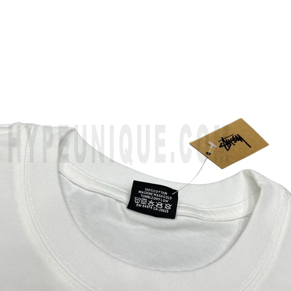 Neckline tag close-up, displaying garment care symbols and brand information with fashion-forward presentation.