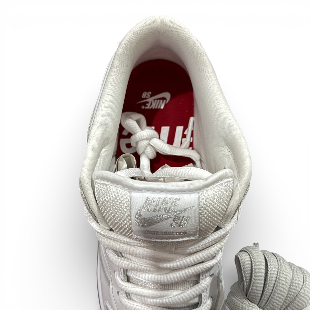 Top view of sneaker interior showing padded lining, tongue label, and lace arrangement
