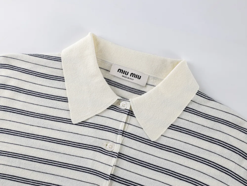 Striped black and white knit shirt with buttons and a cream collar.