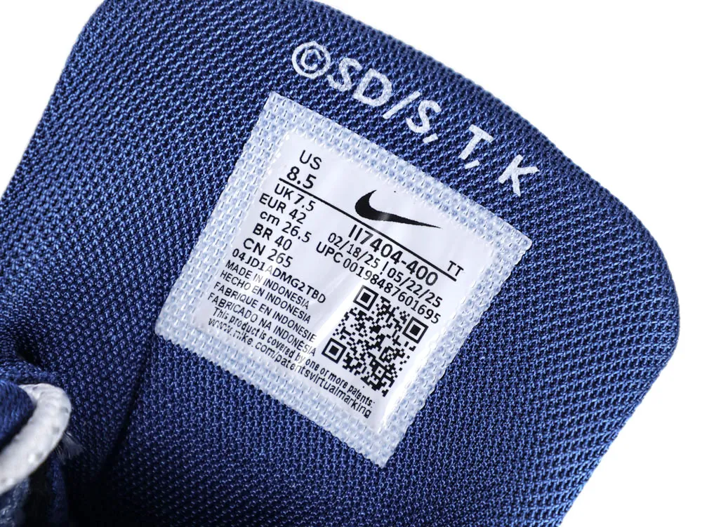Blue fabric shoe tongue featuring a white label with printed product information.