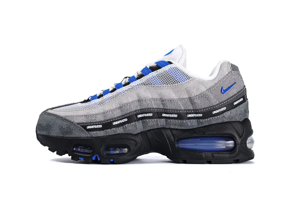 Gray suede and mesh sneaker with blue accents and black sole featuring air cushioning.