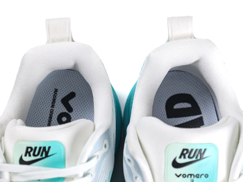 Close-up of white and teal sneakers with padded fabric interior and branded insoles.