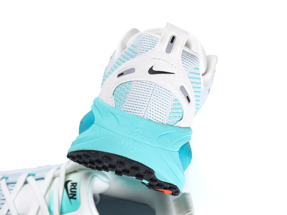 Turquoise and white sneaker with mesh upper and durable rubber sole.