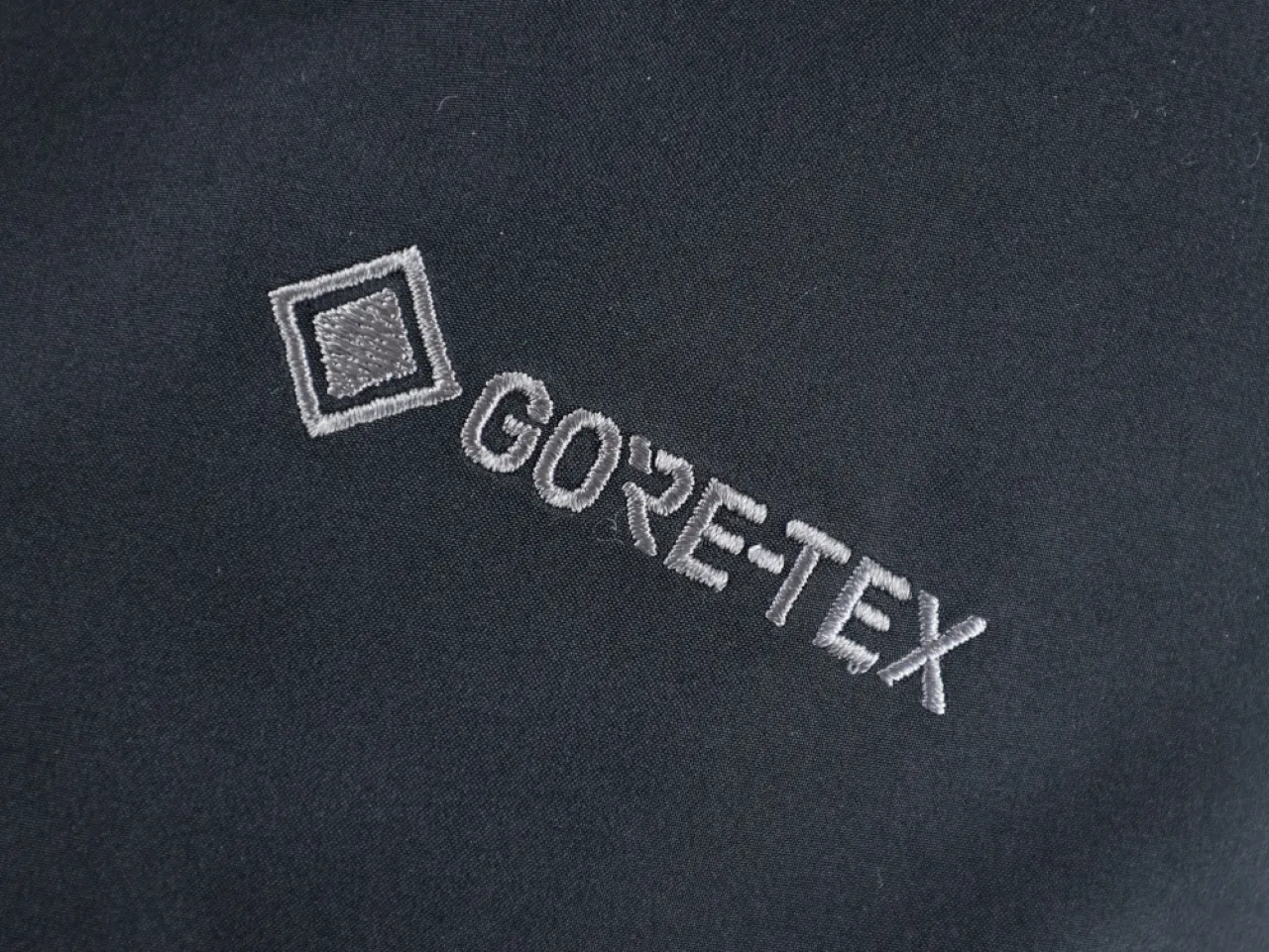 Black GORE-TEX fabric with embroidered logo