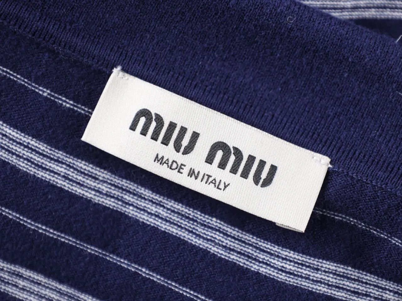 Blue striped fabric with white label, made of soft knit material.