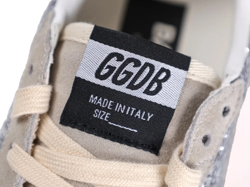 Close-up of the GGDB Made in Italy logo patch on the sneaker tongue