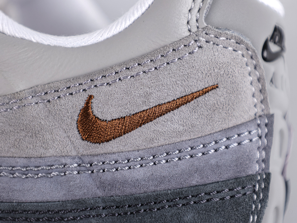 Stylish sneaker with gray and brown accents.