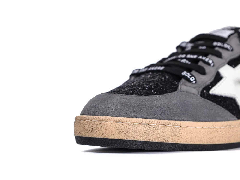 Close-up of grey suede toe box and black glitter on Golden Goose Ball Star sneaker.