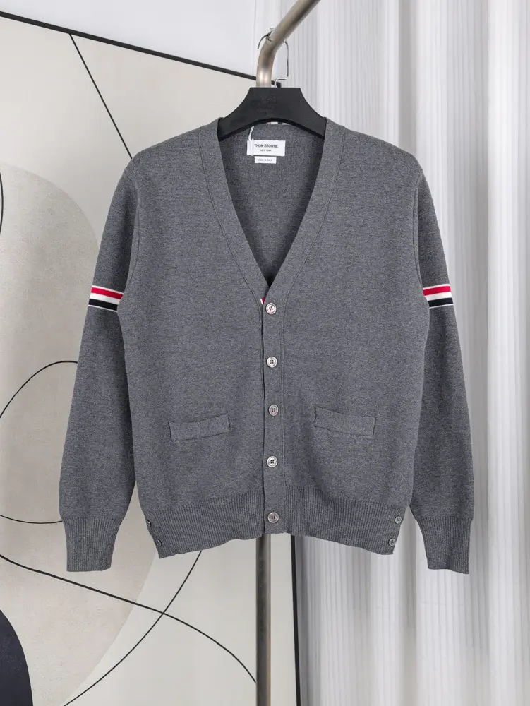 A front view of the Fine Merino Wool RWB Armband Cardigan in grey, showcasing its grey merino wool material.