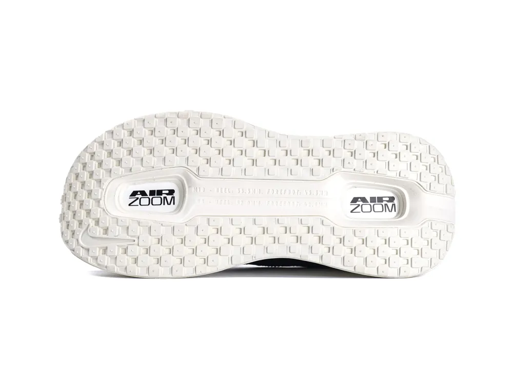 White rubber sole of a shoe, featuring a textured pattern and "Air Zoom" branding.