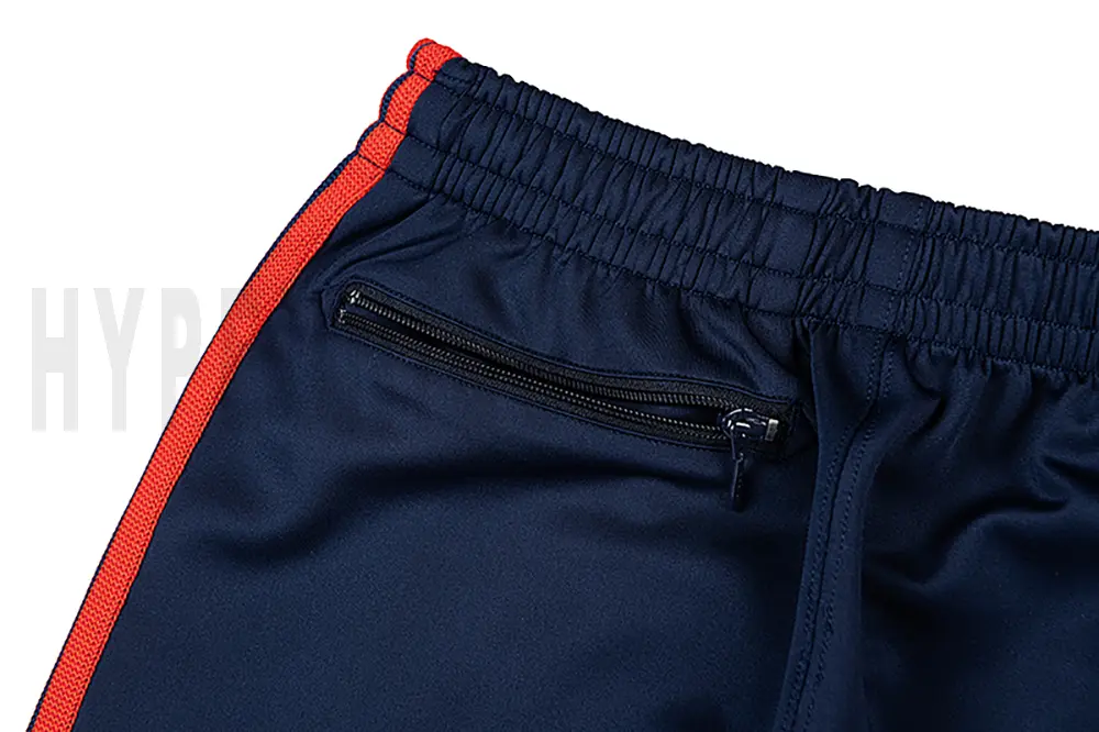 Detail of the back zip pocket on the track pants.